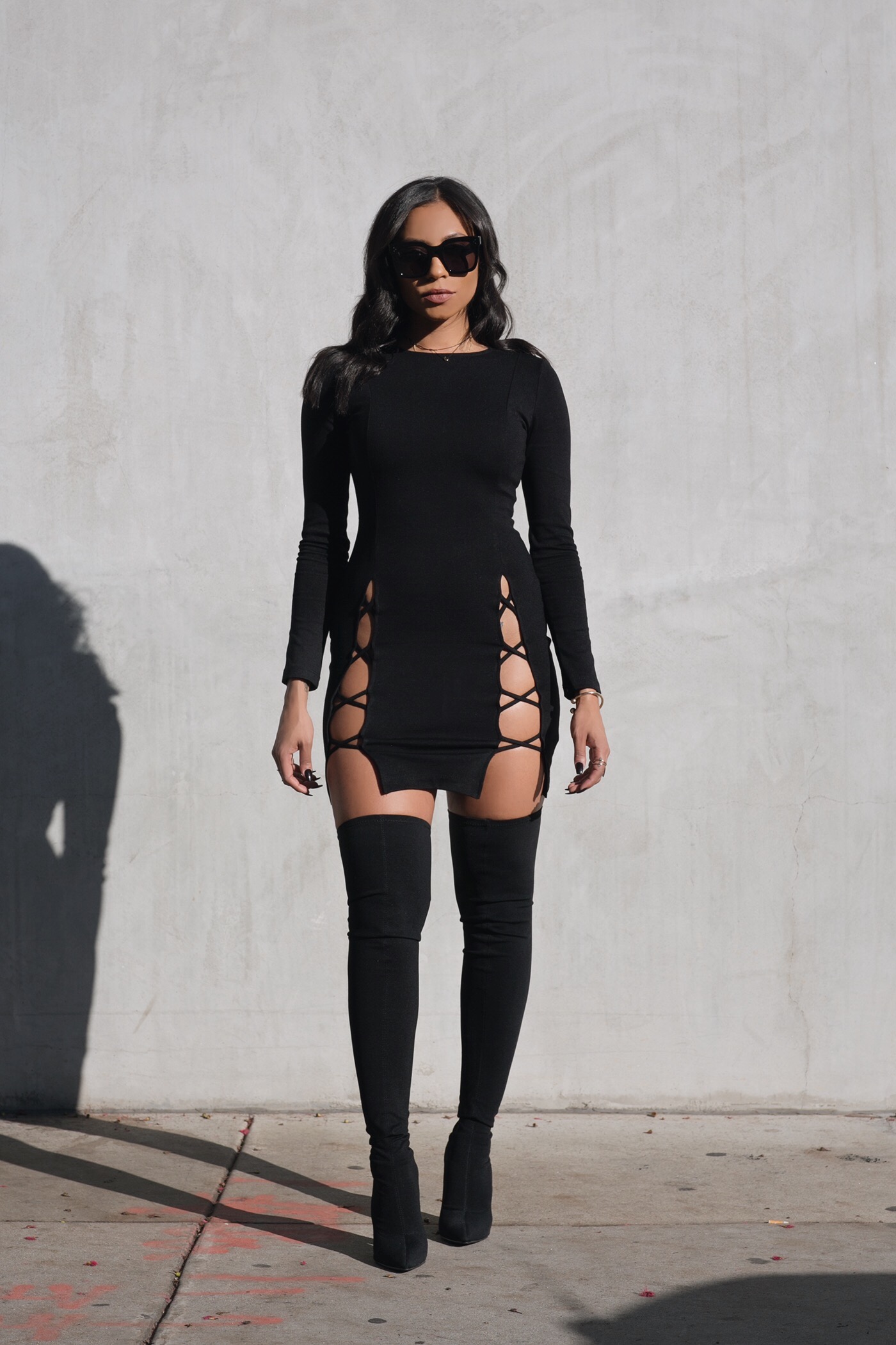 black dress with thigh high boots